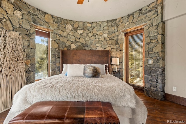 bedroom with dark wood-type flooring and ceiling fan