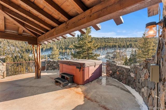 142 Outpost Ln, Evergreen, CO 80439 - view of patio / terrace with a hot tub and a forest view