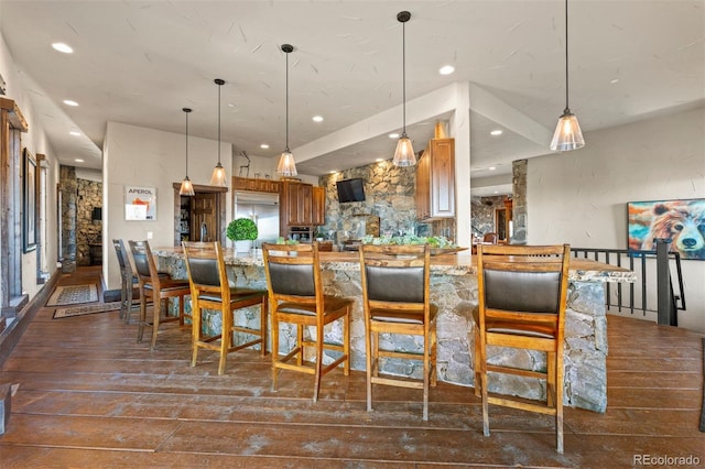 142 Outpost Ln, Evergreen, CO 80439 - kitchen with built in fridge, dark wood-style floors, recessed lighting, hanging light fixtures, and brown cabinets