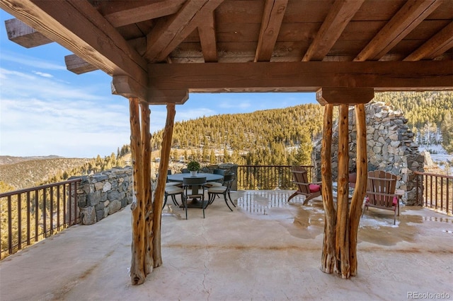 142 Outpost Ln, Evergreen, CO 80439 - view of patio / terrace with a mountain view, outdoor dining area, and a forest view