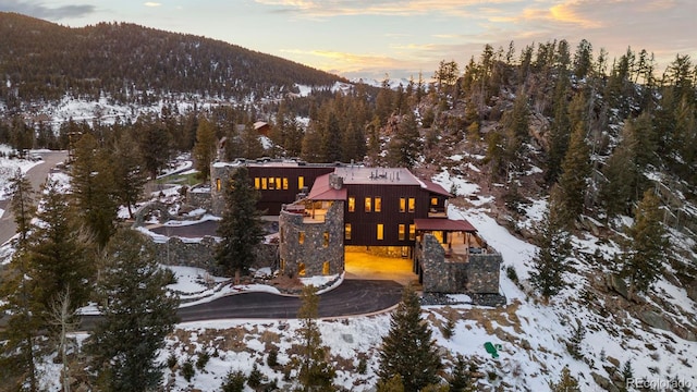 142 Outpost Ln, Evergreen, CO 80439 - snowy aerial view featuring a mountain view and a view of trees