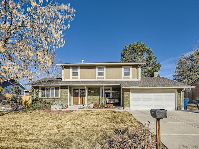 traditional-style house featuring brick siding, an attached garage, driveway, and a front lawn