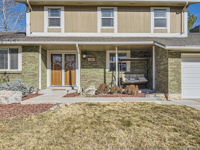 view of front of home featuring a porch, brick siding, and a shingled roof