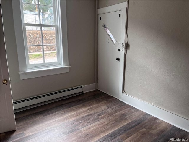 401 Rose St, Georgetown, CO 80444 - empty room featuring a baseboard heating unit, wood finished floors, and a textured wall