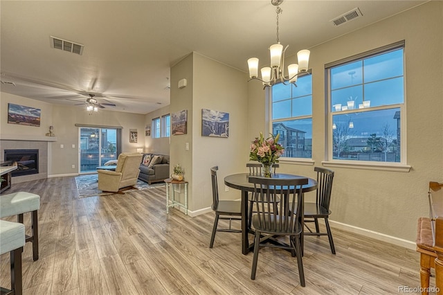 dining area featuring baseboards, visible vents, and light wood-style flooring