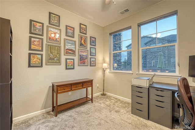 home office featuring baseboards, visible vents, light carpet, and ceiling fan