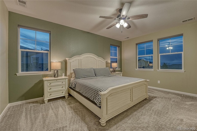 bedroom featuring carpet flooring, baseboards, and visible vents