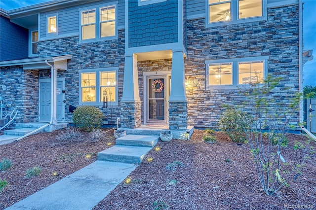 doorway to property featuring stone siding