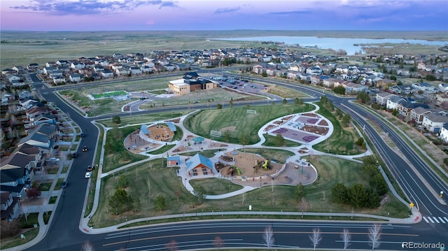 drone / aerial view with a residential view and a water view