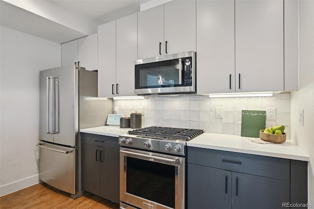 1238 N Tennyson St, Denver, CO 80204 - kitchen featuring baseboards, light wood finished floors, stainless steel appliances, and backsplash