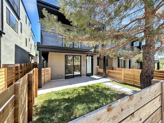 1238 N Tennyson St, Denver, CO 80204 - rear view of property with brick siding, fence private yard, and a patio area