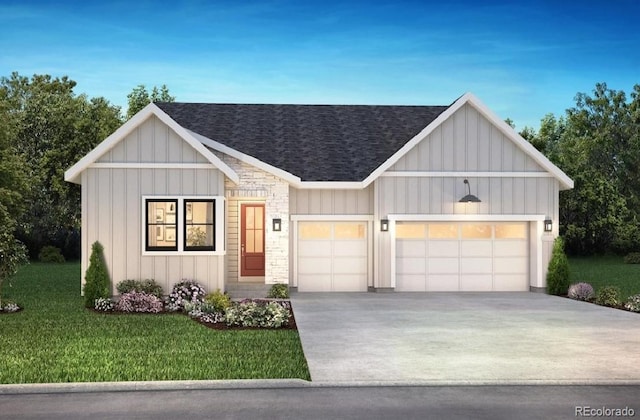 view of front of property with a garage and a front lawn