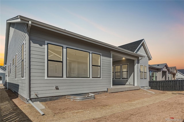 rear view of house featuring fence