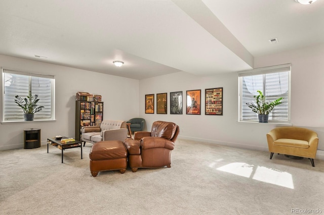 living area featuring visible vents, baseboards, and carpet floors