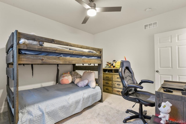 carpeted bedroom featuring visible vents and a ceiling fan