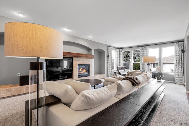 carpeted living area featuring a fireplace and recessed lighting