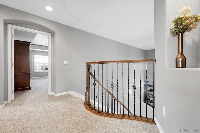 corridor with recessed lighting, an upstairs landing, baseboards, and carpet floors