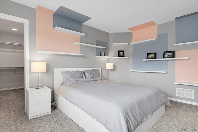 carpeted bedroom with a closet, visible vents, recessed lighting, a walk in closet, and baseboards