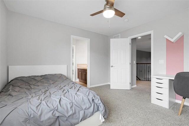 bedroom featuring ensuite bathroom, light colored carpet, visible vents, a ceiling fan, and baseboards