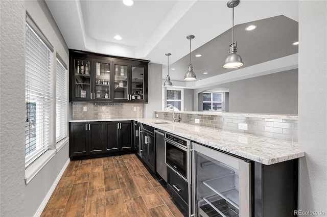 bar with wine cooler, dark wood-style floors, tasteful backsplash, and a sink