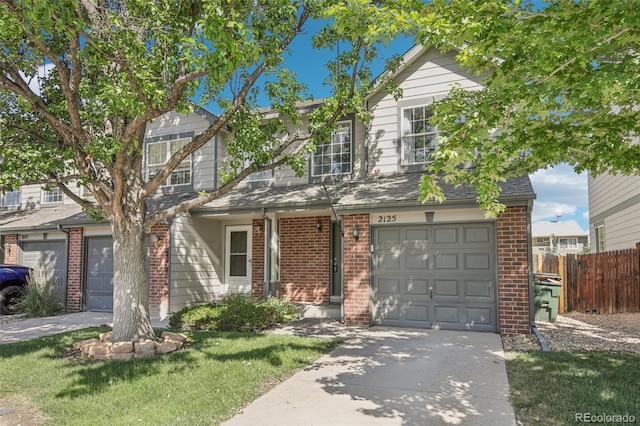 2125 E 103rd Ave, Thornton, CO 80229 - traditional-style home featuring brick siding, a garage, and driveway