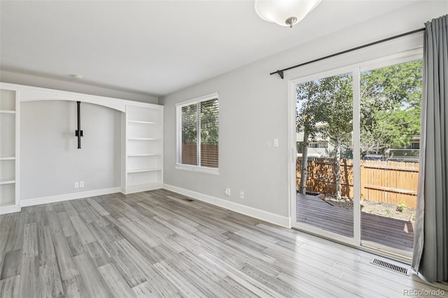 2125 E 103rd Ave, Thornton, CO 80229 - unfurnished room featuring wood finished floors and built in shelves