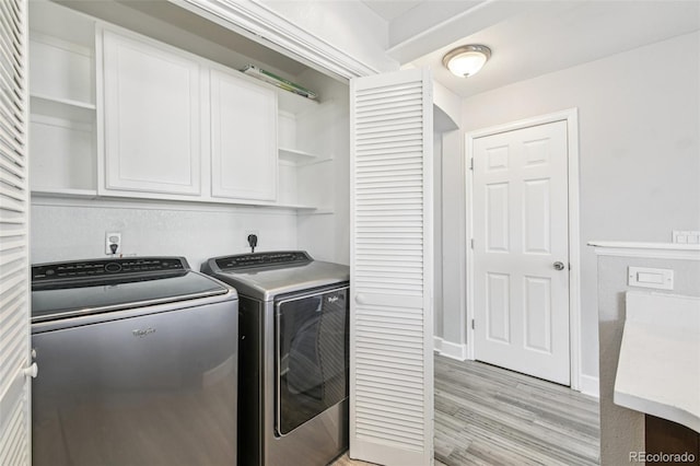 2125 E 103rd Ave, Thornton, CO 80229 - laundry room featuring cabinet space, washing machine and dryer, and light wood-style floors