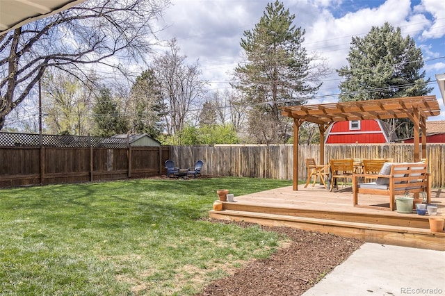 view of yard featuring a pergola, a fenced backyard, and a deck