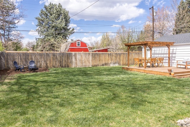 view of yard featuring a fenced backyard, a pergola, a deck, and outdoor dining space