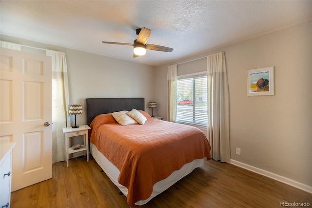 bedroom with light wood-style floors, a ceiling fan, and baseboards