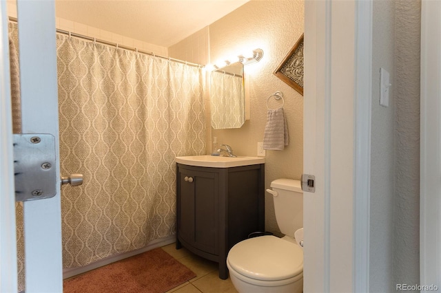 bathroom featuring toilet, tile patterned floors, and vanity