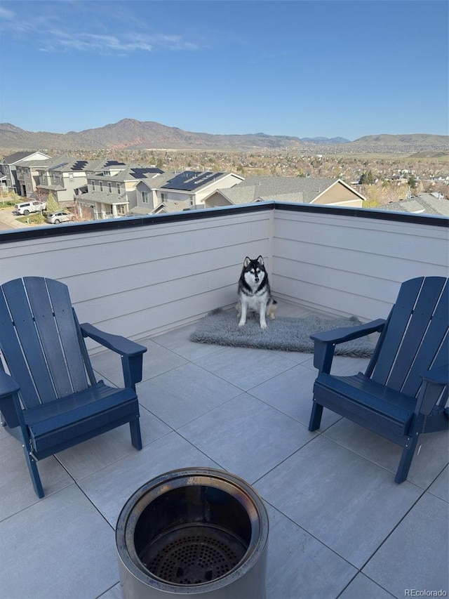 view of patio / terrace featuring a mountain view, a residential view, and a balcony