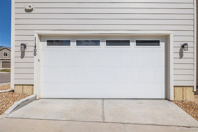 garage featuring concrete driveway