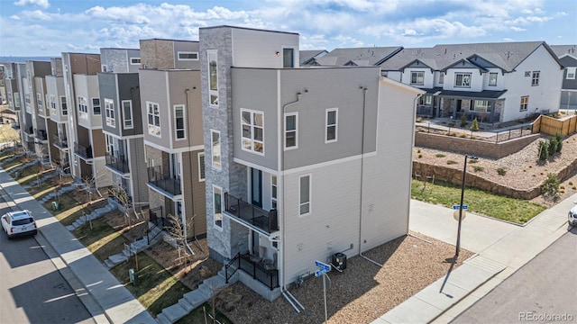 view of building exterior with central AC unit and a residential view