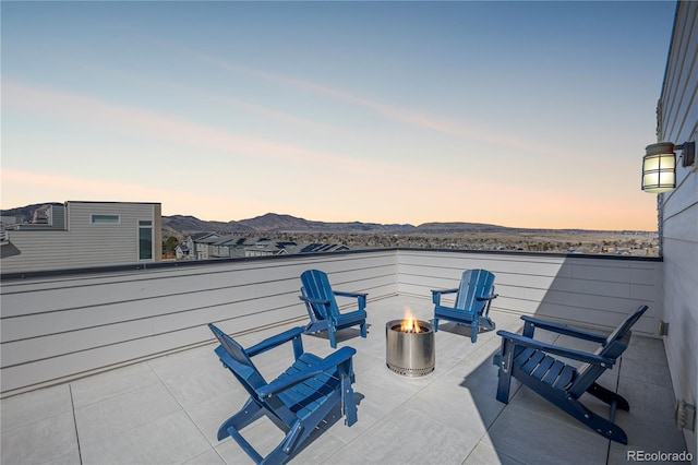 view of patio featuring a mountain view and an outdoor fire pit