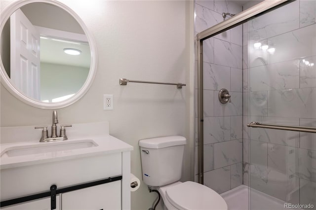 bathroom with vanity, an enclosed shower, and toilet