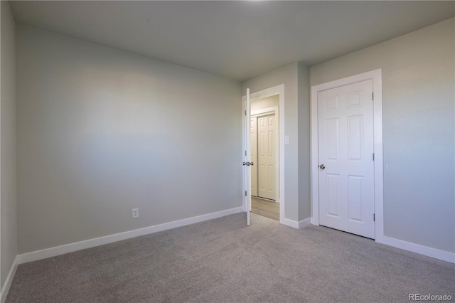 unfurnished bedroom with light colored carpet