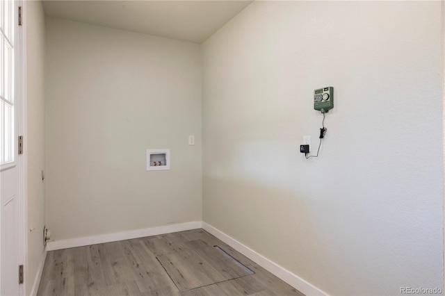 laundry room with washer hookup and light hardwood / wood-style flooring