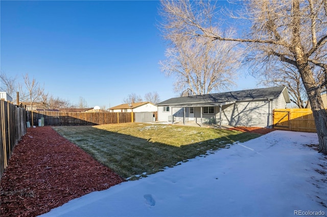 snow covered property featuring a yard and a patio