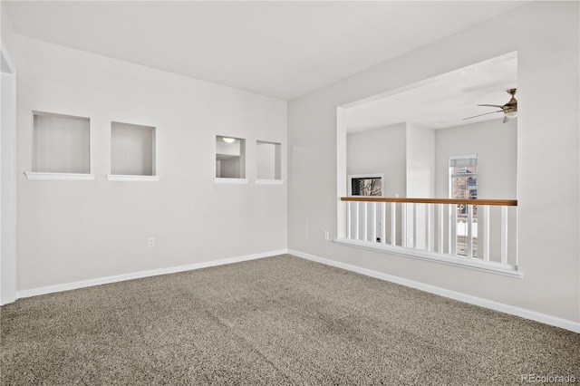 spare room with carpet floors and ceiling fan