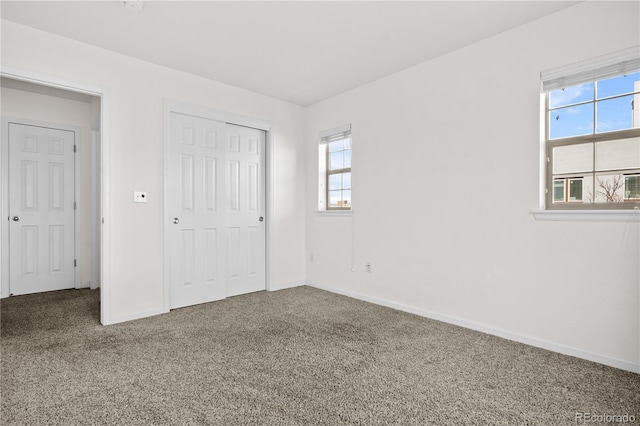 unfurnished bedroom featuring a closet and carpet