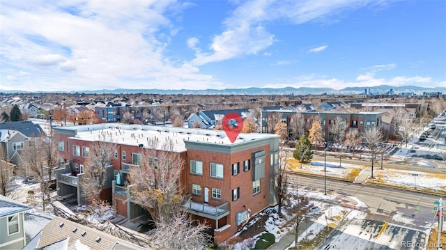 snowy aerial view with a mountain view