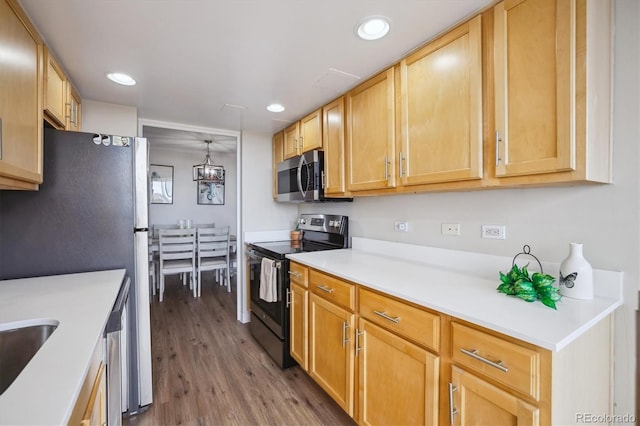 kitchen featuring light countertops, stainless steel appliances, recessed lighting, and wood finished floors