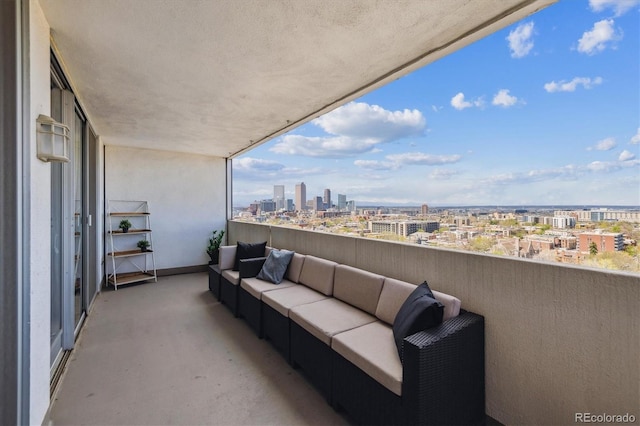 balcony with an outdoor living space and a city view
