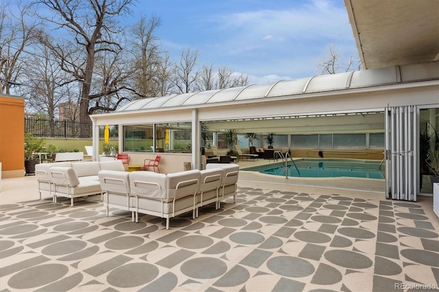 exterior space featuring a patio, outdoor lounge area, and fence