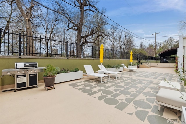 view of patio / terrace with area for grilling and fence