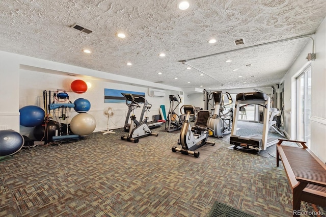 workout area featuring an AC wall unit, recessed lighting, carpet, and visible vents