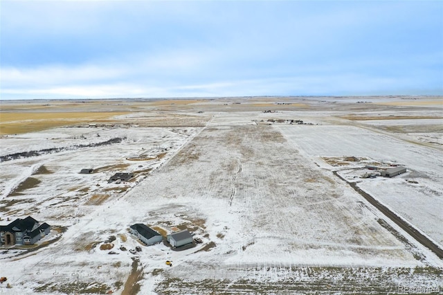 snowy aerial view featuring a rural view