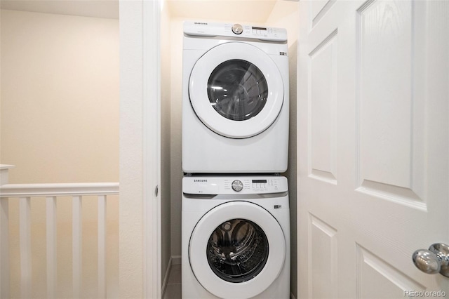 clothes washing area with laundry area and stacked washer / drying machine