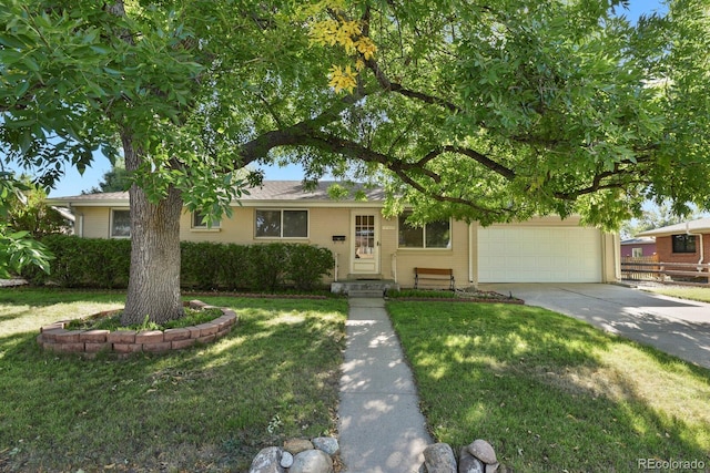 view of front of house featuring a garage and a front lawn